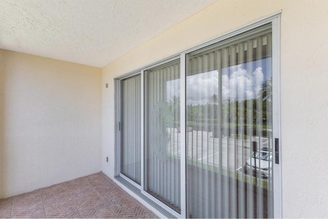 4444 NE Ocean Blvd Unit C2, Jensen Beach, FL 34957 - view of exterior entry with stucco siding and a balcony
