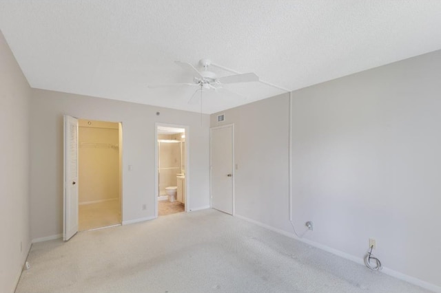 4444 NE Ocean Blvd Unit C2, Jensen Beach, FL 34957 - unfurnished bedroom with light colored carpet, a closet, a walk in closet, and ensuite bath
