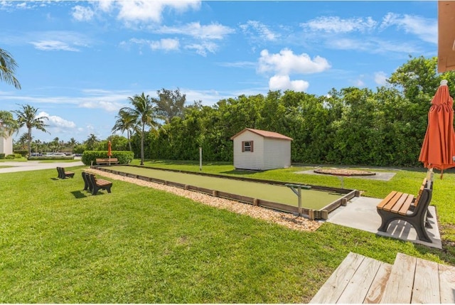 4444 NE Ocean Blvd Unit C2, Jensen Beach, FL 34957 - view of grassy yard with a game area and a storage shed