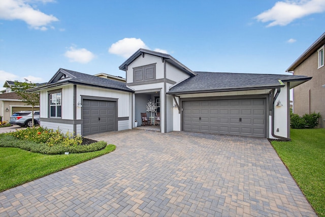 1529 Heron Nook Rd, Loxahatchee, FL 33470 - view of front facade featuring a garage, decorative driveway, a front yard, and roof with shingles