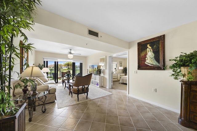 601 Seafarer Cir Unit 104, Jupiter, FL 33477 - living room featuring dark tile patterned flooring and a ceiling fan