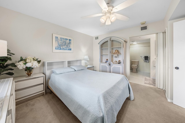 601 Seafarer Cir Unit 104, Jupiter, FL 33477 - carpeted bedroom with ensuite bath and a ceiling fan