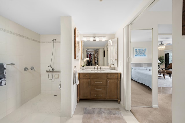 601 Seafarer Cir Unit 104, Jupiter, FL 33477 - ensuite bathroom featuring a walk in shower, vanity, ceiling fan, and tile patterned flooring