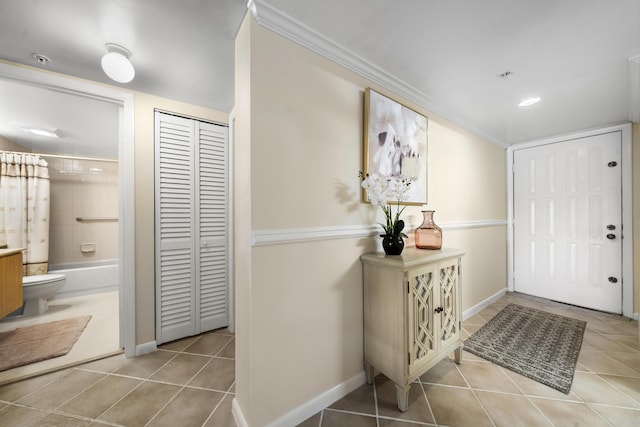 601 Seafarer Cir Unit 104, Jupiter, FL 33477 - foyer entrance featuring tile patterned flooring, crown molding, and recessed lighting