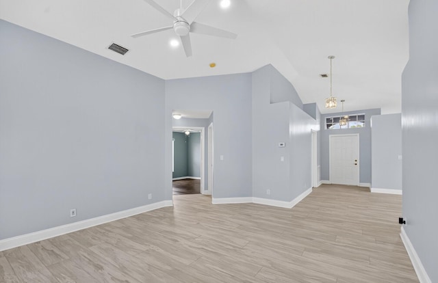 8182 Duomo Cir, Boynton Beach, FL 33472 - empty room featuring ceiling fan, light wood-type flooring, a chandelier, and vaulted ceiling
