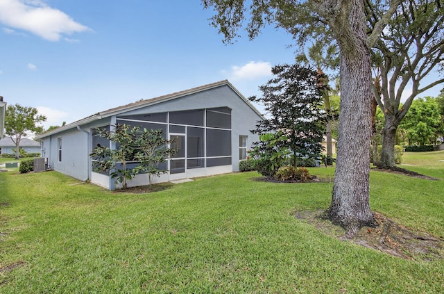8182 Duomo Cir, Boynton Beach, FL 33472 - back of property with stucco siding, a lawn, and a sunroom