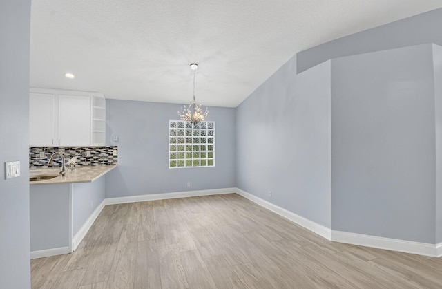 8182 Duomo Cir, Boynton Beach, FL 33472 - unfurnished dining area featuring light wood-style flooring, a chandelier, and recessed lighting