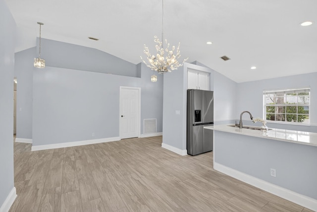 8182 Duomo Cir, Boynton Beach, FL 33472 - kitchen featuring stainless steel fridge with ice dispenser, lofted ceiling, a chandelier, light countertops, and recessed lighting