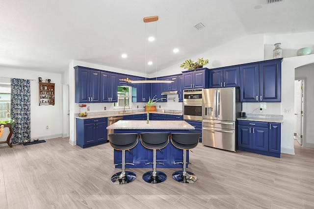 1037 SW Romaine Ln, Port Saint Lucie, FL 34953 - kitchen with stainless steel appliances, blue cabinets, a center island, a breakfast bar area, and vaulted ceiling