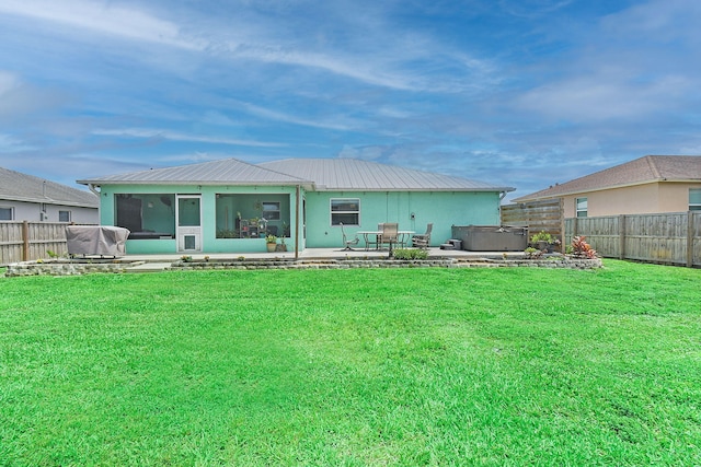 1037 SW Romaine Ln, Port Saint Lucie, FL 34953 - rear view of property featuring a hot tub, a fenced backyard, a patio area, and a metal roof
