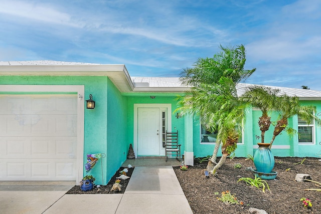 1037 SW Romaine Ln, Port Saint Lucie, FL 34953 - view of exterior entry with stucco siding and a garage