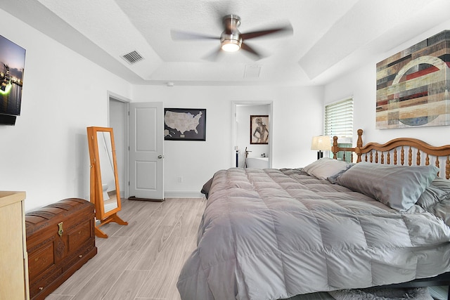 1037 SW Romaine Ln, Port Saint Lucie, FL 34953 - bedroom with a tray ceiling, light wood-style flooring, and ceiling fan