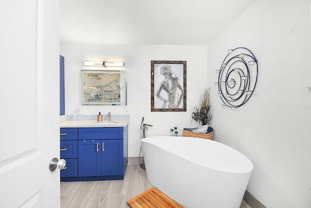 1037 SW Romaine Ln, Port Saint Lucie, FL 34953 - full bathroom featuring a soaking tub, vanity, and wood finished floors