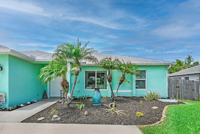1037 SW Romaine Ln, Port Saint Lucie, FL 34953 - view of front facade with stucco siding and a metal roof
