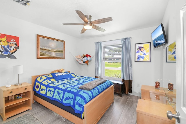 1037 SW Romaine Ln, Port Saint Lucie, FL 34953 - bedroom with wood finished floors and a ceiling fan