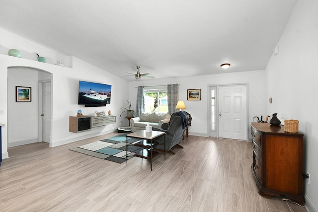 1037 SW Romaine Ln, Port Saint Lucie, FL 34953 - living room with arched walkways, light wood-style flooring, ceiling fan, and vaulted ceiling