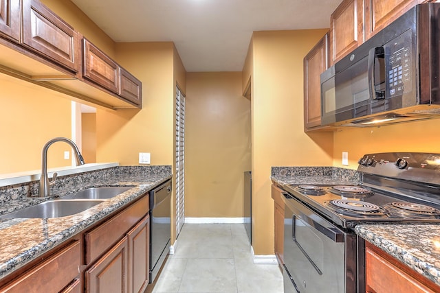 6545 SE Federal Hwy Unit 102, Stuart, FL 34997 - kitchen with black appliances, brown cabinets, and dark stone countertops