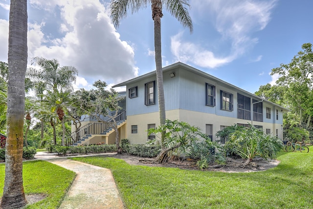6545 SE Federal Hwy Unit 102, Stuart, FL 34997 - view of side of property with a lawn and stairway