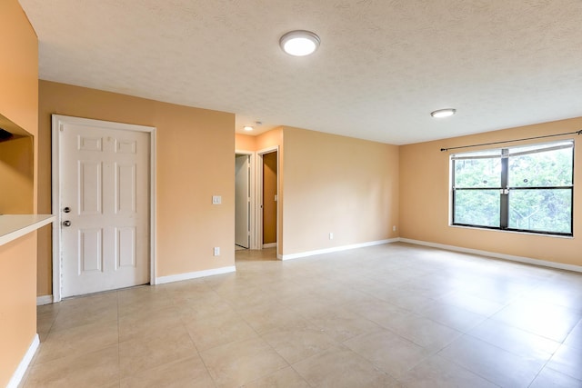 6545 SE Federal Hwy Unit 102, Stuart, FL 34997 - spare room featuring light tile patterned floors and a textured ceiling