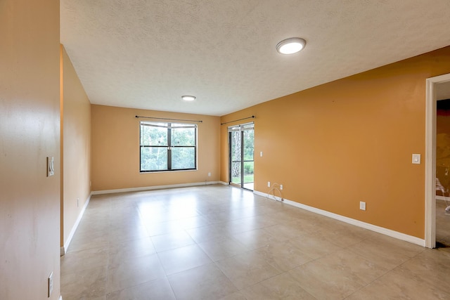6545 SE Federal Hwy Unit 102, Stuart, FL 34997 - unfurnished room with a textured ceiling and light tile patterned floors