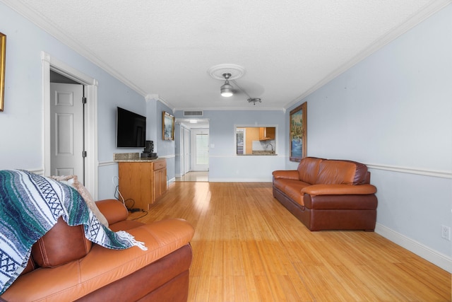 5961 NW 61st Ave Unit 203, Tamarac, FL 33319 - living room with light wood-type flooring, crown molding, and a textured ceiling