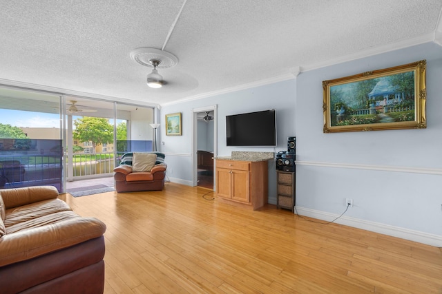 5961 NW 61st Ave Unit 203, Tamarac, FL 33319 - living room featuring a textured ceiling, crown molding, and light wood-style floors