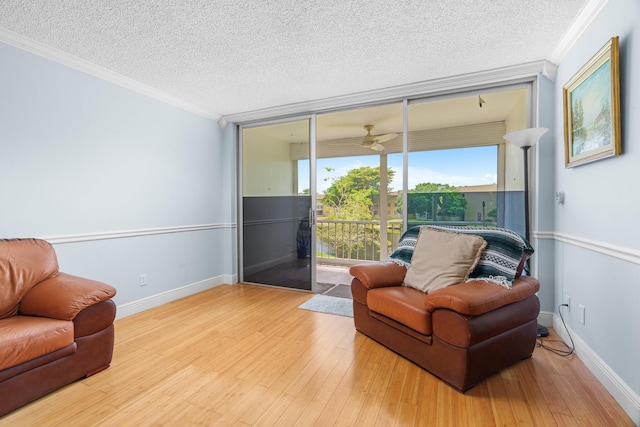 5961 NW 61st Ave Unit 203, Tamarac, FL 33319 - living area featuring crown molding, a textured ceiling, wood finished floors, and a ceiling fan