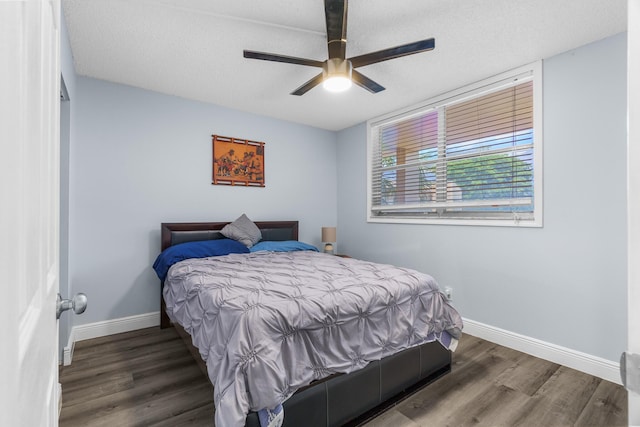 5961 NW 61st Ave Unit 203, Tamarac, FL 33319 - bedroom featuring wood finished floors, a textured ceiling, and ceiling fan