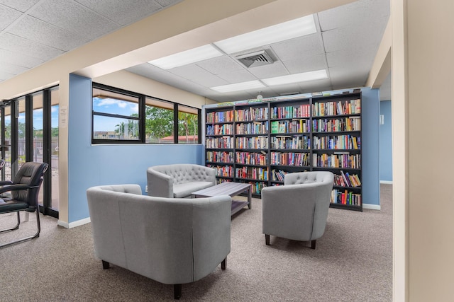 5961 NW 61st Ave Unit 203, Tamarac, FL 33319 - living area featuring a paneled ceiling and carpet flooring