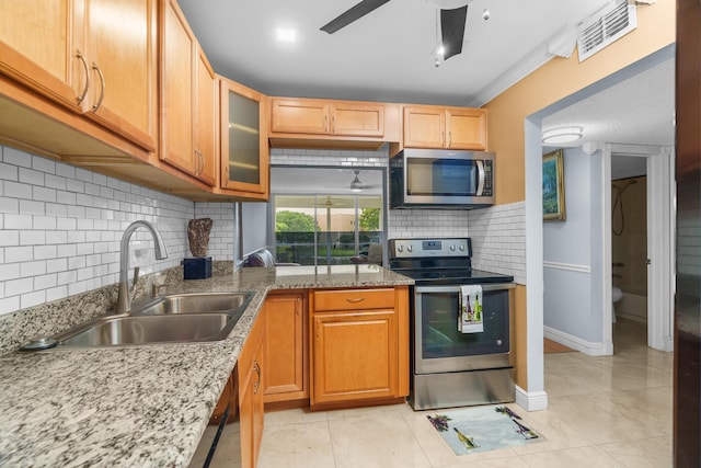 5961 NW 61st Ave Unit 203, Tamarac, FL 33319 - kitchen with appliances with stainless steel finishes, tasteful backsplash, ceiling fan, glass insert cabinets, and light stone countertops