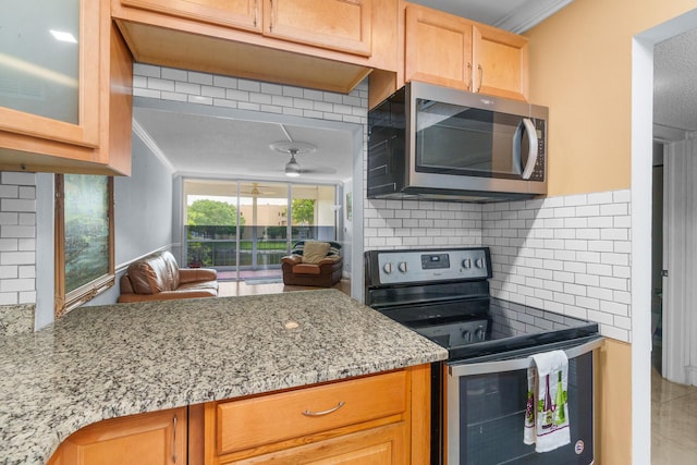 5961 NW 61st Ave Unit 203, Tamarac, FL 33319 - kitchen featuring stainless steel appliances, ornamental molding, ceiling fan, tasteful backsplash, and light stone counters