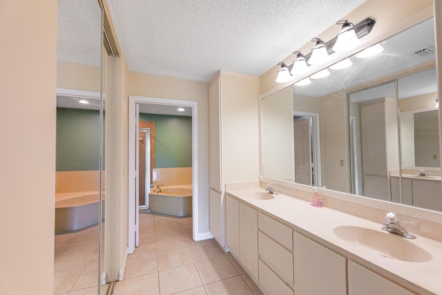2322 SW Olympic Club Ter, Palm City, FL 34990 - full bathroom with a garden tub, double vanity, tile patterned floors, and a textured ceiling
