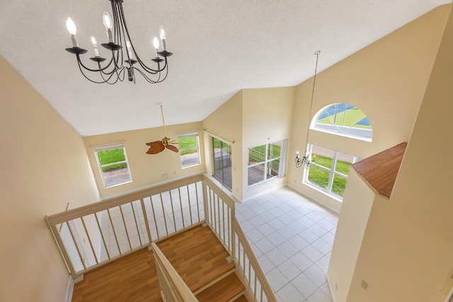 2322 SW Olympic Club Ter, Palm City, FL 34990 - stairway featuring a chandelier, wood finished floors, and high vaulted ceiling