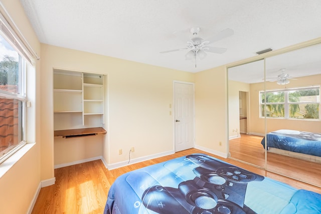 2322 SW Olympic Club Ter, Palm City, FL 34990 - bedroom featuring wood finished floors, a closet, and ceiling fan