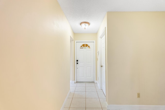 2322 SW Olympic Club Ter, Palm City, FL 34990 - doorway to outside featuring a textured ceiling and light tile patterned flooring