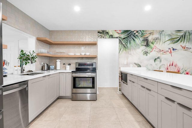 29 SE 8th Ave, Deerfield Beach, FL 33441 - kitchen featuring stainless steel appliances, light countertops, open shelves, gray cabinets, and recessed lighting