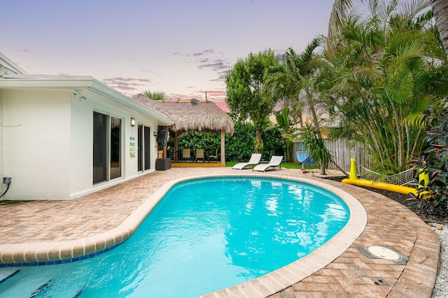 29 SE 8th Ave, Deerfield Beach, FL 33441 - pool at dusk featuring a patio