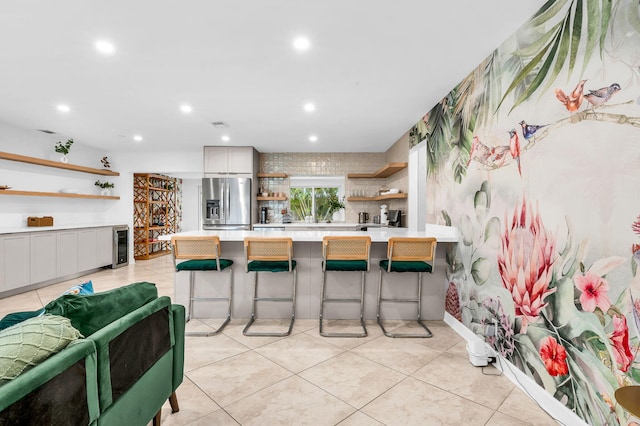 29 SE 8th Ave, Deerfield Beach, FL 33441 - kitchen with open shelves, stainless steel refrigerator with ice dispenser, light countertops, recessed lighting, and a breakfast bar