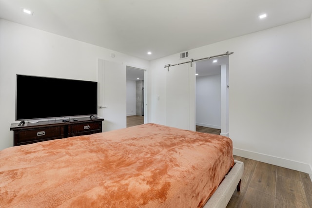 2845 SW 22nd Ave Unit 2070, Delray Beach, FL 33445 - bedroom featuring wood finished floors, a barn door, and recessed lighting