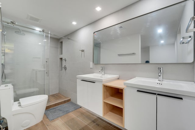 2845 SW 22nd Ave Unit 2070, Delray Beach, FL 33445 - bathroom with a shower stall, vanity, wood finished floors, and recessed lighting