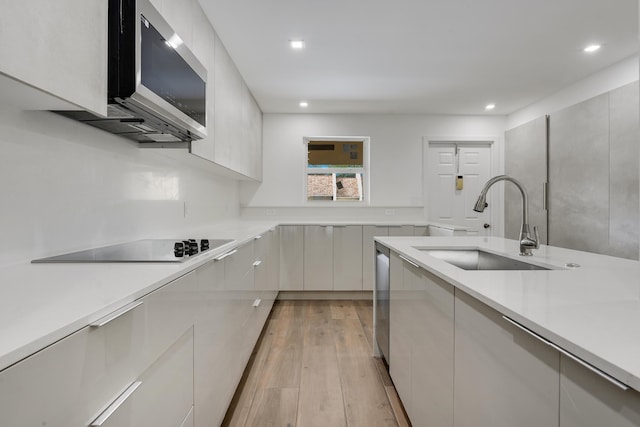 2845 SW 22nd Ave Unit 2070, Delray Beach, FL 33445 - kitchen with appliances with stainless steel finishes, modern cabinets, light countertops, recessed lighting, and light wood-style flooring