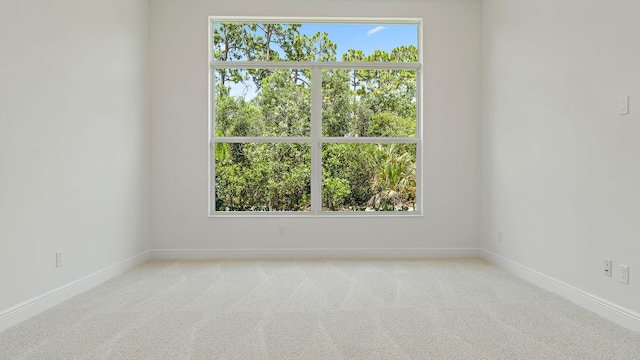 204 SE Via Sangro, Port Saint Lucie, FL 34952 - spare room with baseboards and carpet flooring