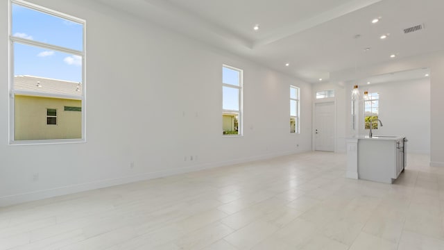 204 SE Via Sangro, Port Saint Lucie, FL 34952 - unfurnished living room featuring healthy amount of natural light and recessed lighting