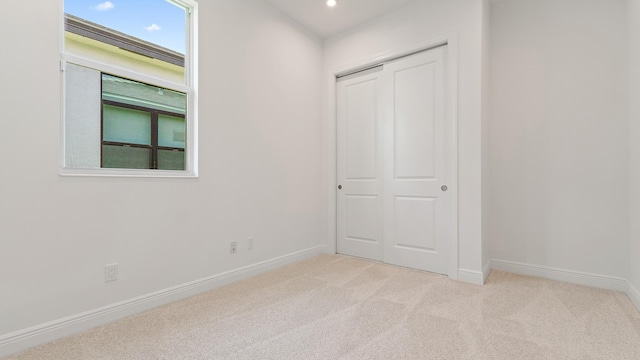 204 SE Via Sangro, Port Saint Lucie, FL 34952 - unfurnished bedroom with light carpet, a closet, and recessed lighting