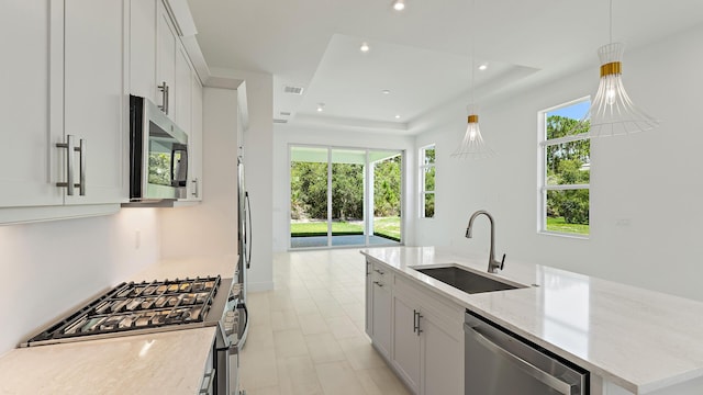 204 SE Via Sangro, Port Saint Lucie, FL 34952 - kitchen with stainless steel appliances, plenty of natural light, a kitchen island with sink, light stone countertops, and recessed lighting