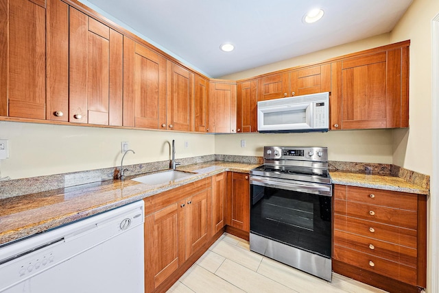5560 Tamberlane Cir Unit 327, Palm Beach Gardens, FL 33418 - kitchen featuring white appliances, light stone countertops, light tile patterned floors, brown cabinets, and recessed lighting