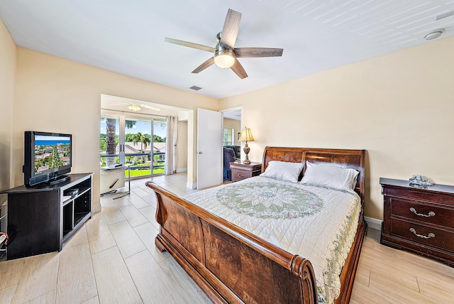 5560 Tamberlane Cir Unit 327, Palm Beach Gardens, FL 33418 - bedroom with a ceiling fan, access to outside, and light wood-style flooring