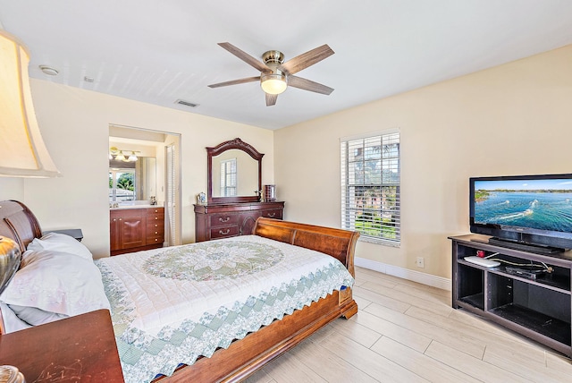 5560 Tamberlane Cir Unit 327, Palm Beach Gardens, FL 33418 - bedroom featuring multiple windows, a ceiling fan, and connected bathroom