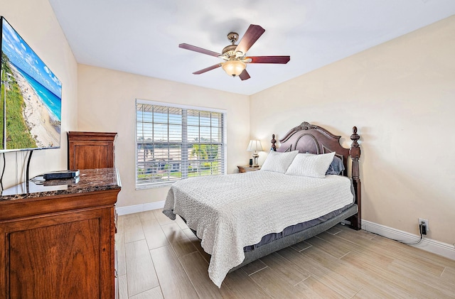 5560 Tamberlane Cir Unit 327, Palm Beach Gardens, FL 33418 - bedroom with a ceiling fan and light wood finished floors