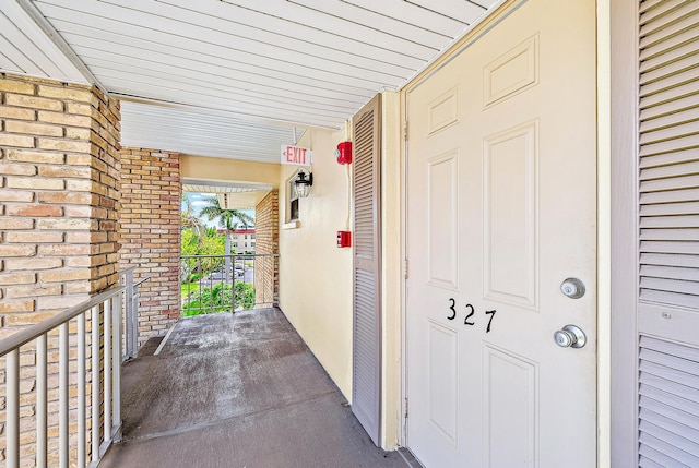 5560 Tamberlane Cir Unit 327, Palm Beach Gardens, FL 33418 - doorway to property featuring brick siding
